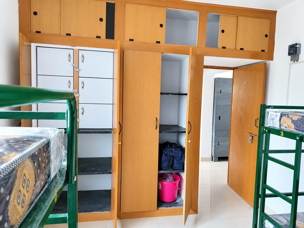 Built-in wooden wardrobe and white cabinets inside a room